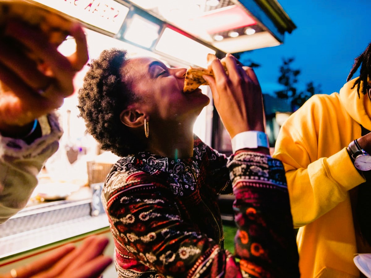 young woman eating pizza